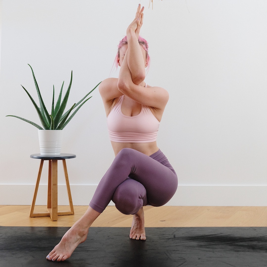 woman practicing an adanced yoga pose