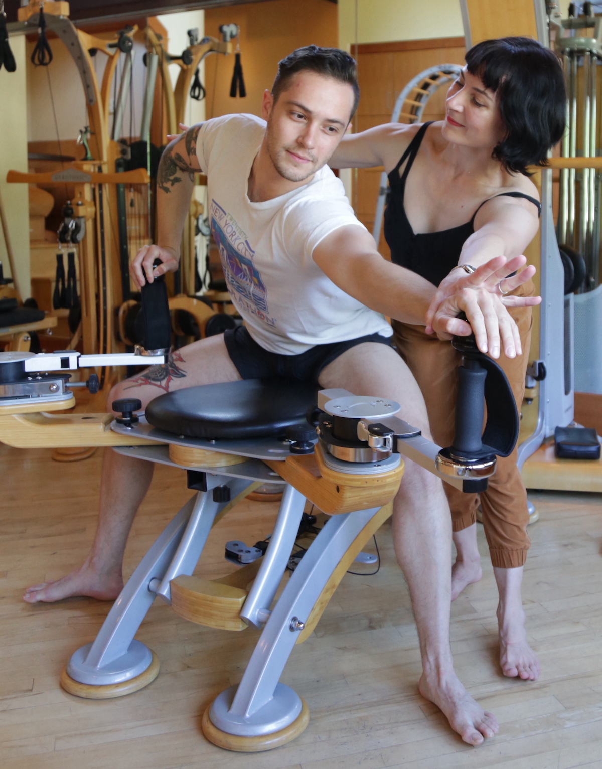 Gyrotonic Trainer Heather Jackson instructing a client on the handles of the Gyrotonic Pully Tower Unit